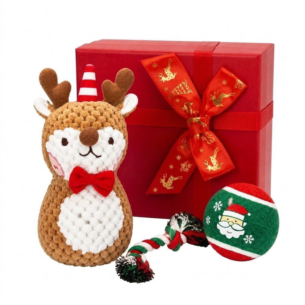 Christmas dog toy set with plush reindeer, rope tug and Santa ball beside gift box