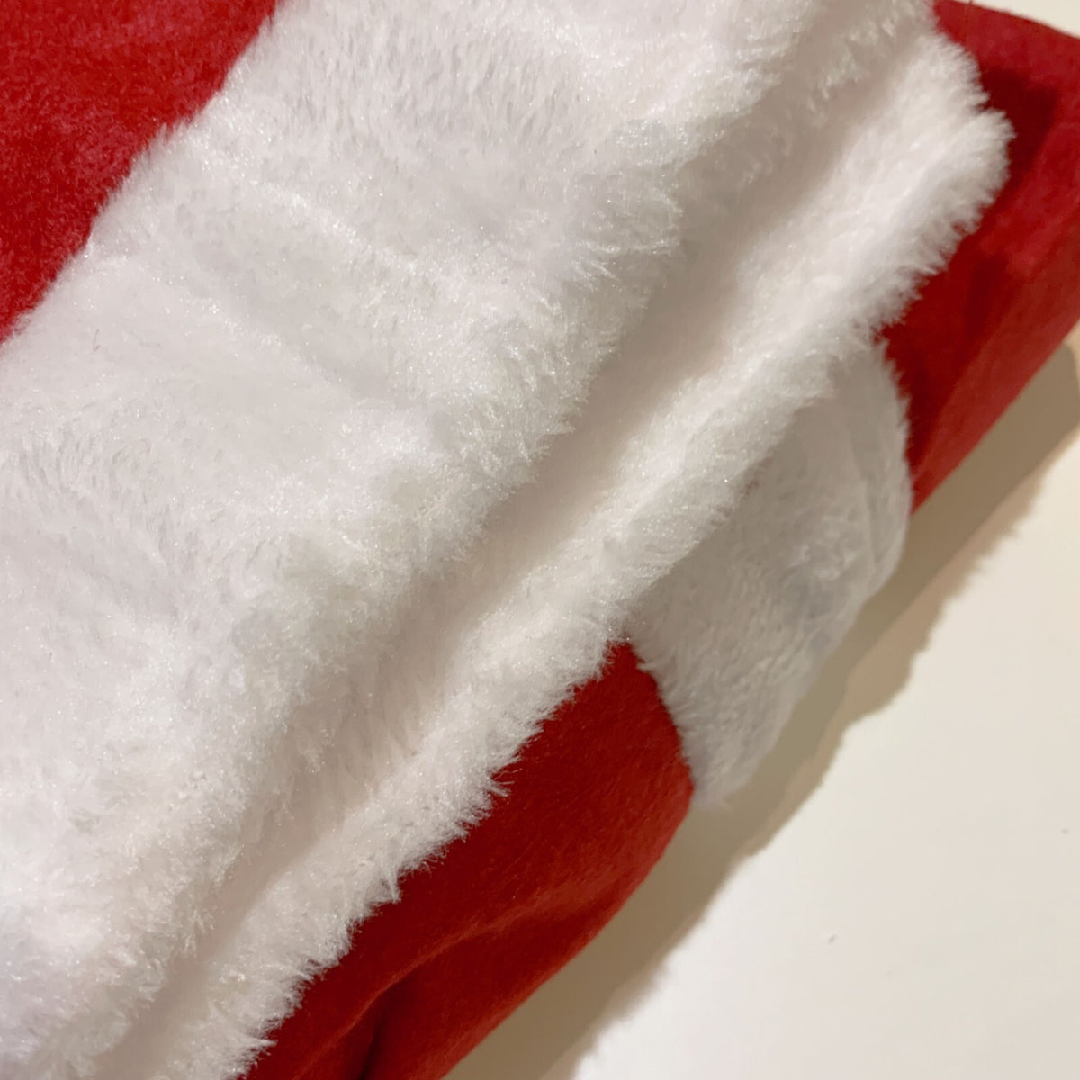 Close-up of the white plush trim on the red Santa costume