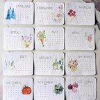 All twelve 2027 seed paper calendar cards January to December laid out in a grid