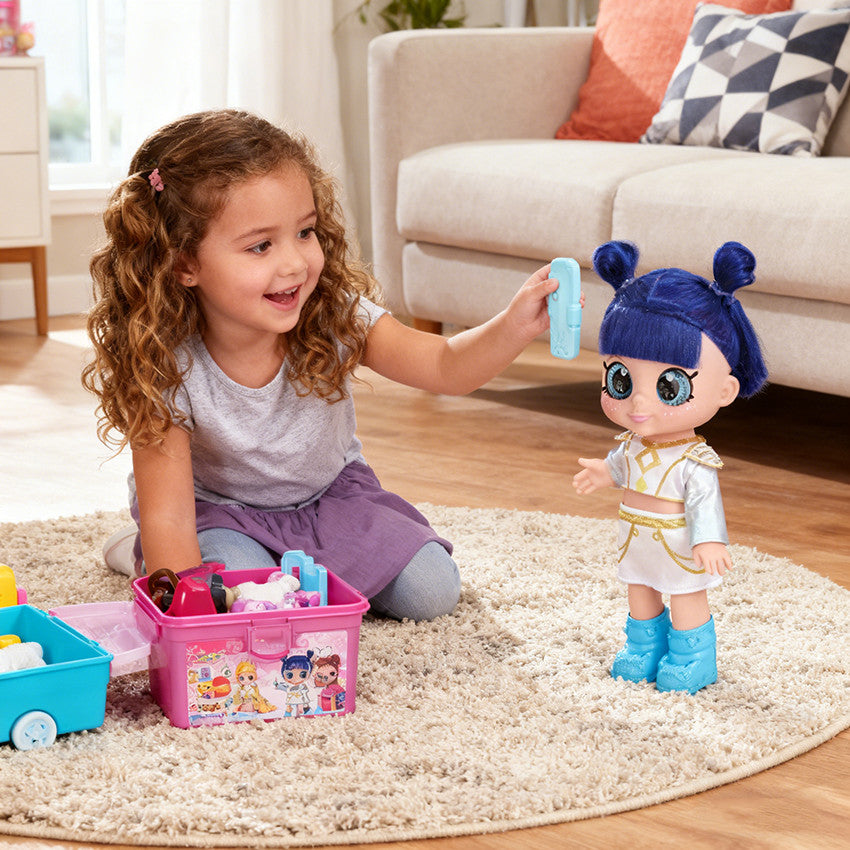 Girl playing with a blue hair big eye doll on the floor