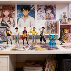 K-pop style mini figures displayed on a desk with posters