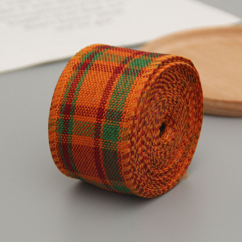 Orange, green and red plaid wired ribbon roll partly unrolled