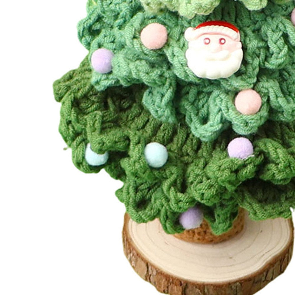 Close-up of dark green crochet Christmas tree stitches with Santa charm