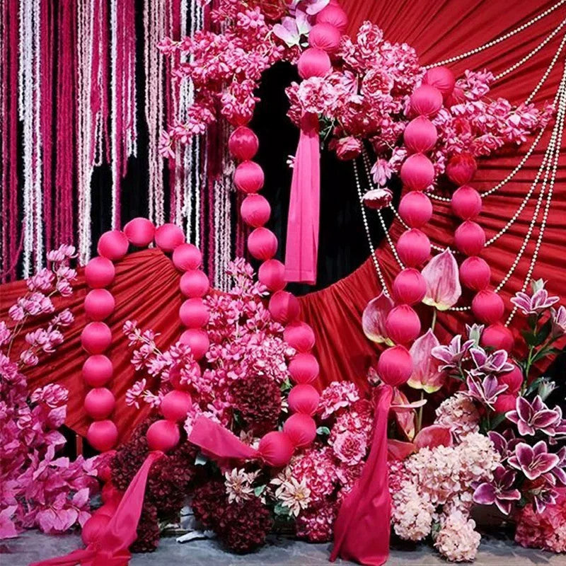 Pink ball garlands at a wedding backdrop