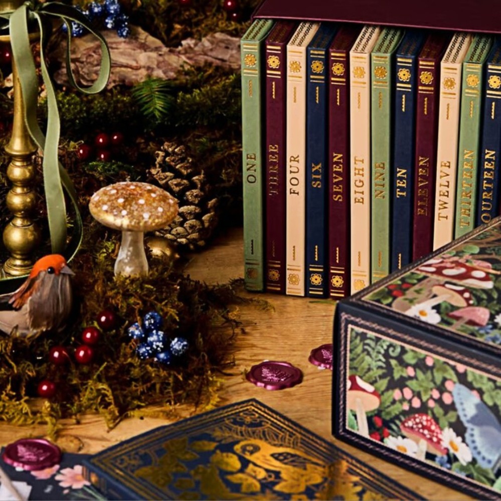24 numbered book-style boxes on a shelf with stationery gifts