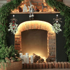 Pair of artificial mistletoe sprigs hung either side of a decorated fireplace mantel
