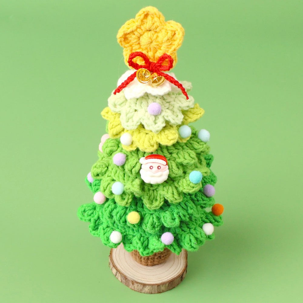 Light green crochet Christmas tree on green background with star topper