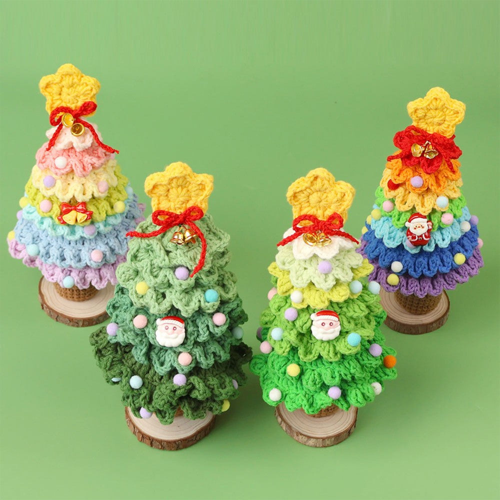 Four crochet Christmas trees in all colourways grouped on a green background