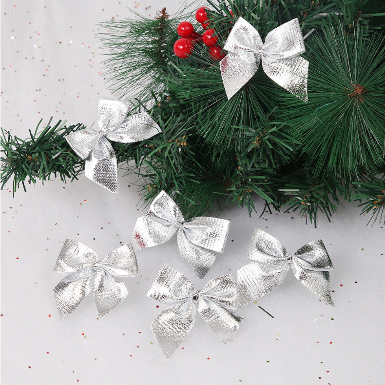 Silver Christmas bows on pine branches