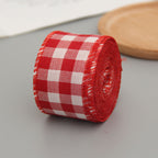 Red and white gingham wired ribbon roll on a wooden board