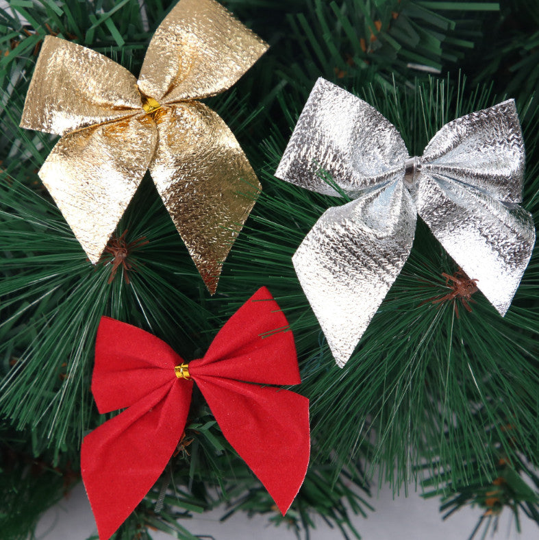 Close-up of gold, silver and red Christmas tree bows