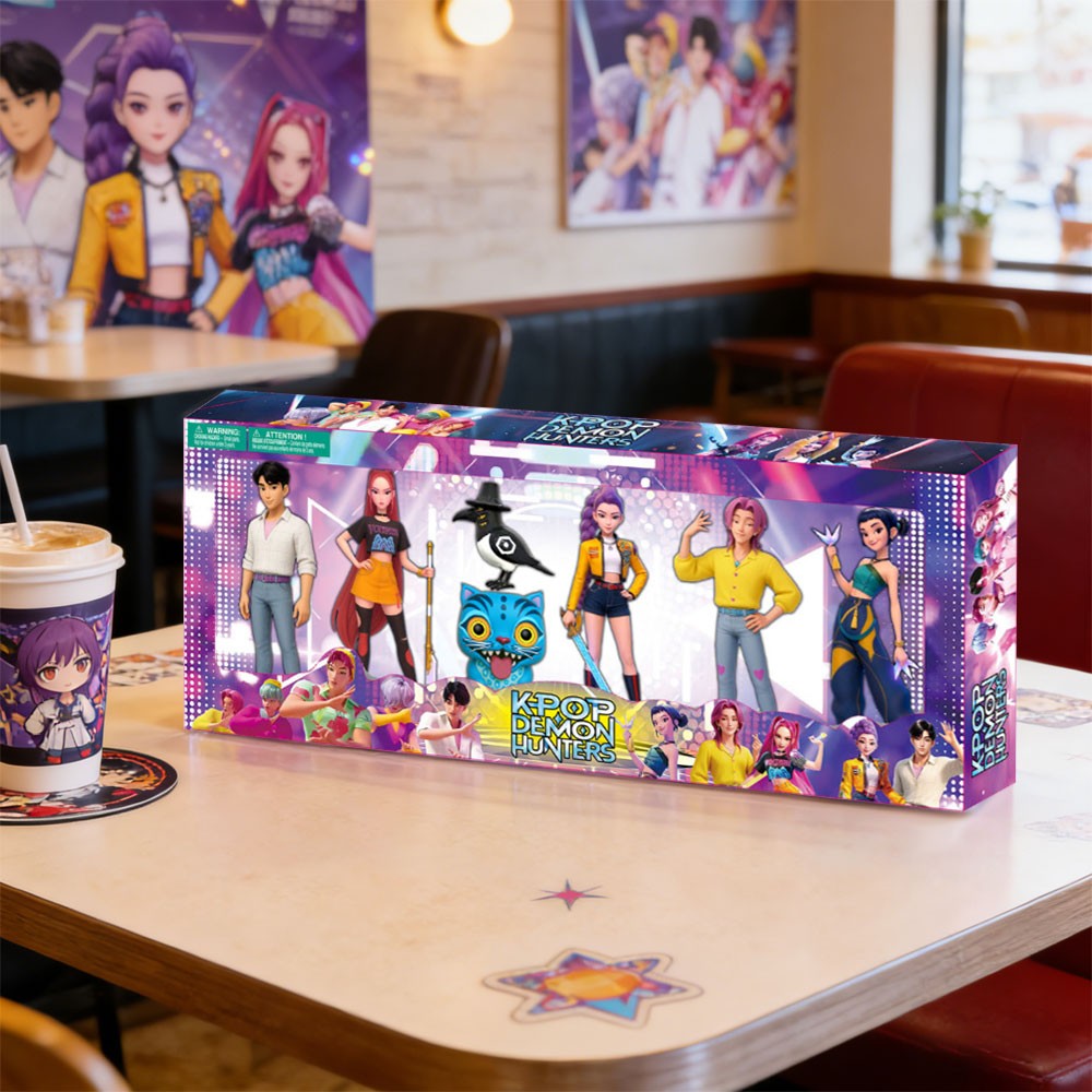 Boxed K-pop style figures on a cafe table