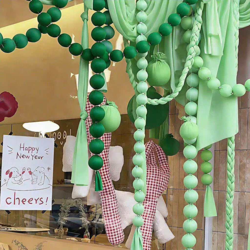Green ball garlands in a shop window