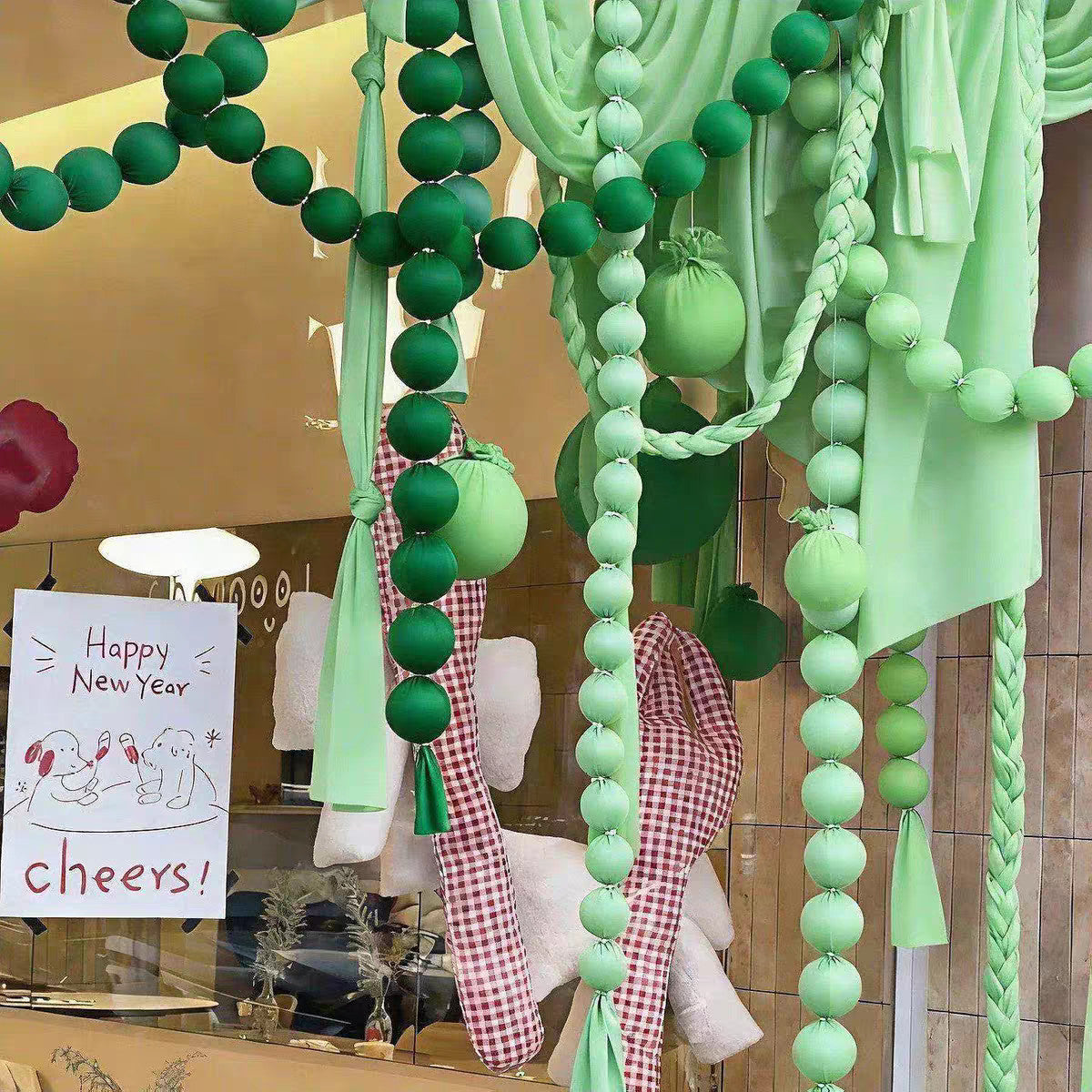 Green ball garlands in a shop window