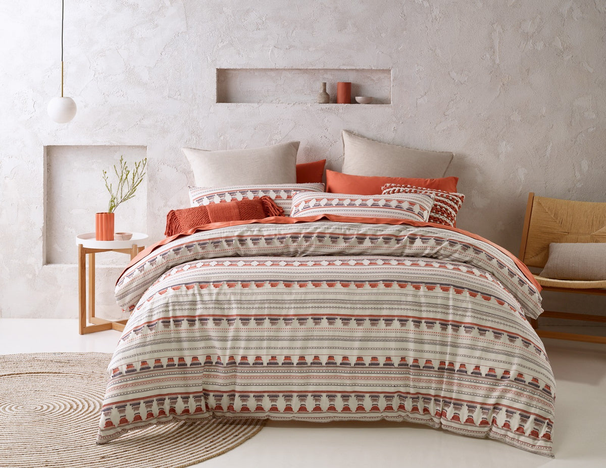 Aztec-style stripe quilt cover with terracotta cushions