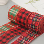 Red tartan wired Christmas ribbon rolls unrolled on a white table