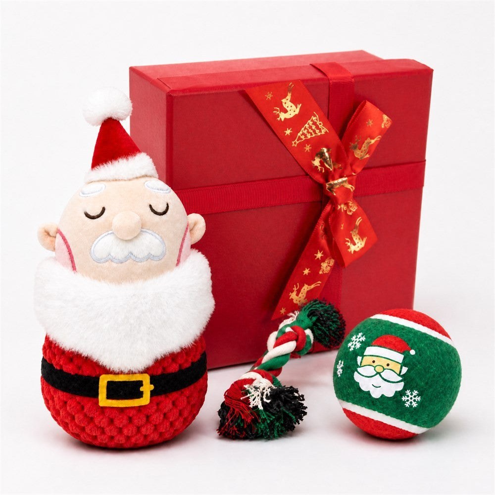 Plush Santa dog toy with rope tug and plush ball in front of red gift box