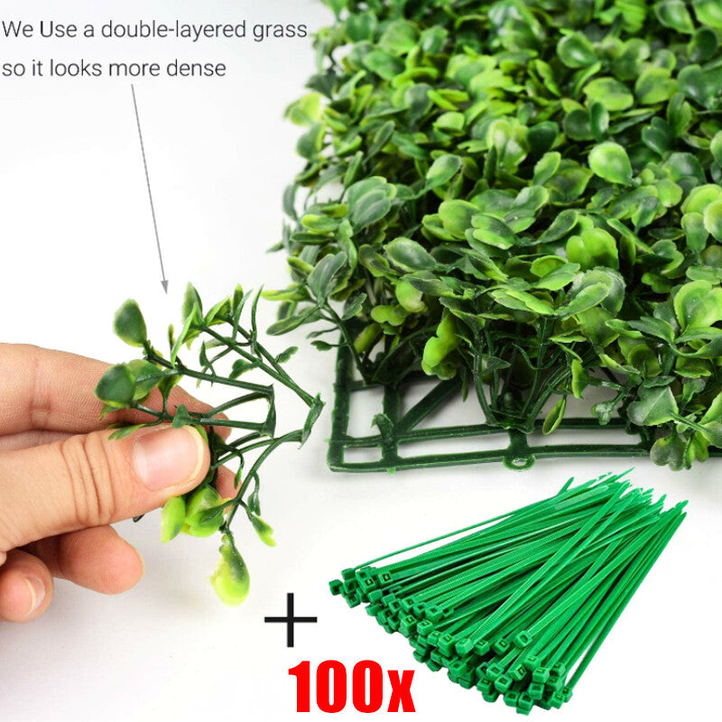 Double-layered artificial leaves on a green wall panel