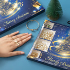 Hand wearing rings beside the blue jewellery advent calendar