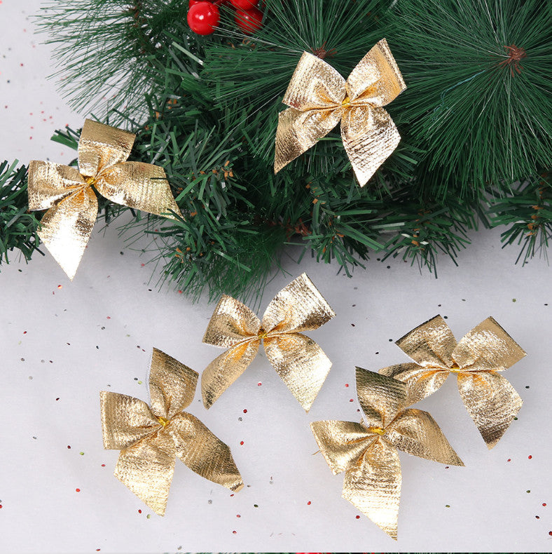 Gold Christmas bow ornaments on pine branches