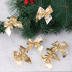 Gold Christmas bow ornaments on pine branches