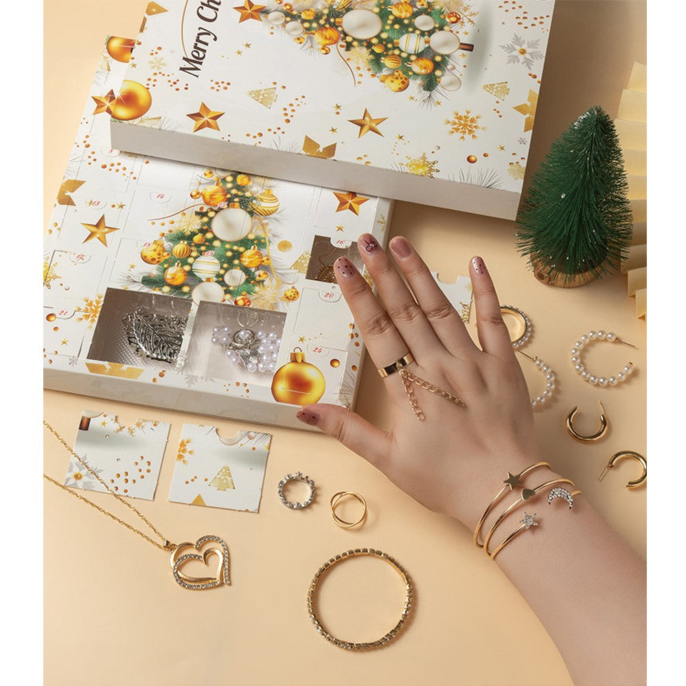 Hand with gold rings and a bracelet over the open jewellery advent calendar